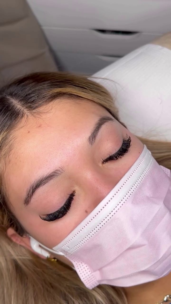 Client in a pink mask showing a wispy set